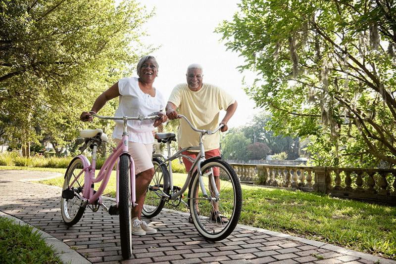 Senior couple riding bikes outdoors